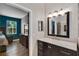 Bathroom with vanity, ensuite access, and decorative mirror at 13214 Triphammer Way, Orlando, FL 32828