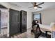 Bedroom features black closet, a twin bed, ceiling fan, natural light and wood floors at 13214 Triphammer Way, Orlando, FL 32828