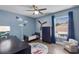 ' bedroom with airplane decor, ceiling fan, daybed, accent chair and natural light at 13214 Triphammer Way, Orlando, FL 32828