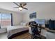 Modern bedroom features desk, computer and a large window letting in lots of natural light at 13214 Triphammer Way, Orlando, FL 32828