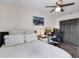 Bedroom features a desk with computer, a twin bed, ceiling fan, and hardwood floors at 13214 Triphammer Way, Orlando, FL 32828