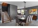 Open dining room featuring modern lighting, gray walls, staircase, and an adjacent kitchen at 13214 Triphammer Way, Orlando, FL 32828