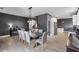 View of the open dining room featuring a rustic table, and access to the kitchen at 13214 Triphammer Way, Orlando, FL 32828
