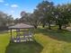 Beautifully maintained community gazebo with benches surrounded by lush landscaping and mature trees at 13214 Triphammer Way, Orlando, FL 32828