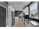 Modern kitchen with stainless steel appliances, white cabinets, and a large farmhouse sink at 13214 Triphammer Way, Orlando, FL 32828