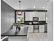 Bright kitchen features stainless steel appliances, white cabinets and dark countertops at 13214 Triphammer Way, Orlando, FL 32828