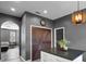Kitchen view showcases a center island with seating, modern lighting and gray walls at 13214 Triphammer Way, Orlando, FL 32828