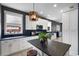Modern kitchen with white cabinets, geometric backsplash, island, and stainless steel appliances at 13214 Triphammer Way, Orlando, FL 32828