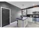 Kitchen featuring a small island, geometric backsplash, and stainless steel appliances at 13214 Triphammer Way, Orlando, FL 32828