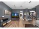 Open-concept living room showcasing modern decor, dark walls, and views to other rooms at 13214 Triphammer Way, Orlando, FL 32828