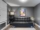 Cozy living room with modern black futon, stylish shelving, and neutral rug on hardwood floors at 13214 Triphammer Way, Orlando, FL 32828