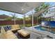Comfortable screened patio with ceiling fan, stylish furniture, and a view of the inviting private pool at 13214 Triphammer Way, Orlando, FL 32828