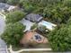 Aerial view of the community pool and playground surrounded by lush greenery and mature trees at 13214 Triphammer Way, Orlando, FL 32828