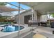 Beautiful backyard with a pristine pool, outdoor television, and barbecue area for entertaining at 13214 Triphammer Way, Orlando, FL 32828