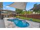 Lovely outdoor pool area with shade sails and well-maintained landscaping at 13214 Triphammer Way, Orlando, FL 32828