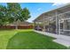 This lovely screened porch offers a great backyard view and a space for outdoor relaxation at 13214 Triphammer Way, Orlando, FL 32828