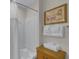 Cozy bathroom with shower, decorative print, and stack of fresh towels at 13415 Blue Heron Beach Dr # 208, Orlando, FL 32821