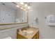 Functional bathroom featuring a single vanity with ample lighting and a framed mirror at 13415 Blue Heron Beach Dr # 208, Orlando, FL 32821