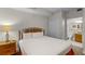Cozy bedroom featuring a plush bed with white linens and a bathroom entrance at 13415 Blue Heron Beach Dr # 208, Orlando, FL 32821