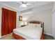 Bedroom features bright lighting, neutral colored walls, and comfortable bedding at 13415 Blue Heron Beach Dr # 208, Orlando, FL 32821
