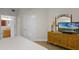 Comfortable bedroom featuring a vanity and TV, perfect for relaxation and entertainment at 13415 Blue Heron Beach Dr # 208, Orlando, FL 32821