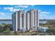 Stunning high-rise condo building with multiple floors and private balconies overlooking the water at 13415 Blue Heron Beach Dr # 208, Orlando, FL 32821