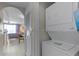 Hallway featuring a stacked washer and dryer, offering laundry convenience in the home at 13415 Blue Heron Beach Dr # 208, Orlando, FL 32821