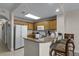 Kitchen featuring granite countertops, bar seating and stainless steel appliances at 13415 Blue Heron Beach Dr # 208, Orlando, FL 32821