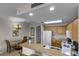 Kitchen features wood cabinets, granite counters and is open to the dining area at 13415 Blue Heron Beach Dr # 208, Orlando, FL 32821