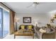 Cozy living room with tile flooring, comfortable seating, and a serene view through sliding glass doors at 13415 Blue Heron Beach Dr # 208, Orlando, FL 32821