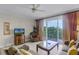 Comfortable living room featuring tile floors, plush seating, and a lovely water view at 13415 Blue Heron Beach Dr # 208, Orlando, FL 32821