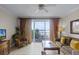 Comfortable living room featuring tile floors, plush seating, and a lovely water view at 13415 Blue Heron Beach Dr # 208, Orlando, FL 32821