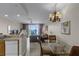 Living room view featuring balcony access, chandelier, and seating area at 13415 Blue Heron Beach Dr # 208, Orlando, FL 32821