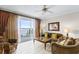 Comfortable living room featuring tile floors, plush seating, and a lovely water view at 13415 Blue Heron Beach Dr # 208, Orlando, FL 32821