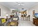 Comfortable living room and kitchen featuring tile floors and furniture at 13415 Blue Heron Beach Dr # 208, Orlando, FL 32821