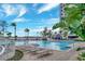 A luxurious pool area with lounge chairs and a cabana at 13415 Blue Heron Beach Dr # 208, Orlando, FL 32821