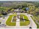 A stunning aerial view of a community featuring a clock tower, clubhouse, and manicured landscaping at 14090 Avenue Of The Groves, Winter Garden, FL 34787