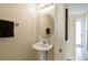 Half bath featuring pedestal sink and modern fixtures near tiled hallway at 14090 Avenue Of The Groves, Winter Garden, FL 34787