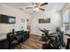 Bedroom featuring hardwood floors, a ceiling fan, and a mounted TV at 14090 Avenue Of The Groves, Winter Garden, FL 34787