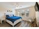 Bright bedroom with three windows, ceiling fan, wood floors and decor at 14090 Avenue Of The Groves, Winter Garden, FL 34787