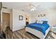 Bedroom with hardwood floors, ensuite bath, and a large bed at 14090 Avenue Of The Groves, Winter Garden, FL 34787