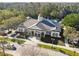 Aerial view of a well-manicured clubhouse with community pool and landscaped grounds at 14090 Avenue Of The Groves, Winter Garden, FL 34787