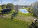 Aerial view of a community dog park with agility equipment, pond, and seating at 14090 Avenue Of The Groves, Winter Garden, FL 34787
