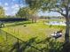 Aerial view of a community dog park with agility equipment, pond, and seating at 14090 Avenue Of The Groves, Winter Garden, FL 34787