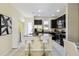 Charming kitchen featuring black cabinets, stainless steel appliances, and a breakfast bar with seating at 14090 Avenue Of The Groves, Winter Garden, FL 34787