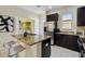 Well-equipped kitchen with granite countertops, stainless steel appliances, and a convenient breakfast bar at 14090 Avenue Of The Groves, Winter Garden, FL 34787