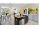 Bright kitchen with an island, seating, and laundry area at 14090 Avenue Of The Groves, Winter Garden, FL 34787