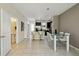 Open floor plan features dining area with a kitchen island and stainless steel appliances at 14090 Avenue Of The Groves, Winter Garden, FL 34787