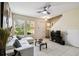 Bright living room features a white sectional, modern ceiling fan, and ample natural light from large windows at 14090 Avenue Of The Groves, Winter Garden, FL 34787