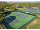 Aerial view of tennis courts within a well-maintained and fenced recreation area at 14090 Avenue Of The Groves, Winter Garden, FL 34787
